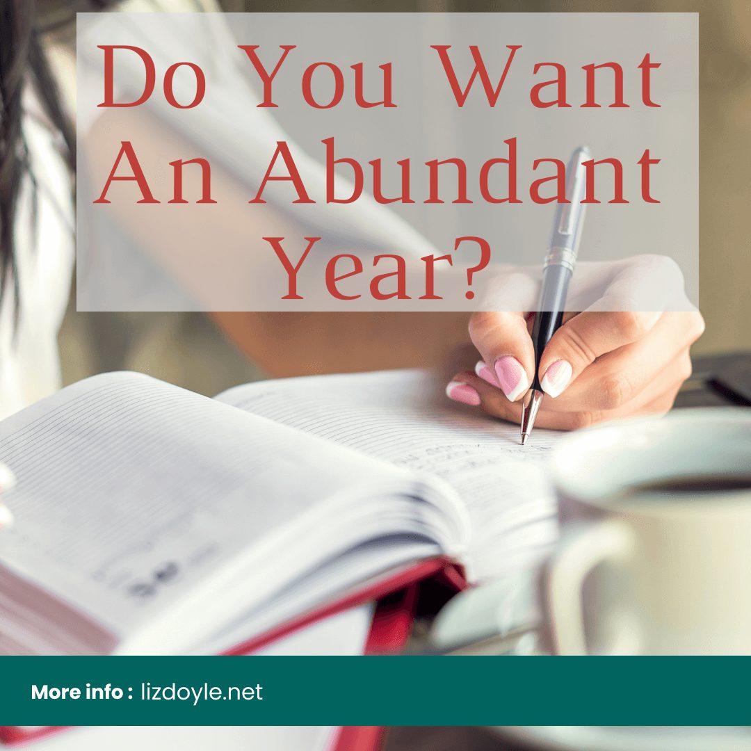 Image of a woman's hand writing and text that says Do You Want An Abundant Year? More Info: lizdoyle.net
