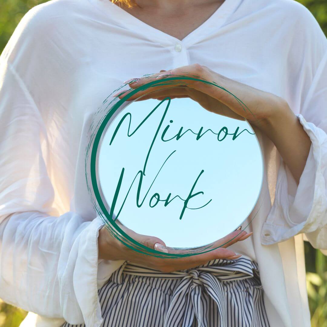 Woman holding a mirror, ready to practise mirror work affirmations for self-love and healing from the Open Your Heart course